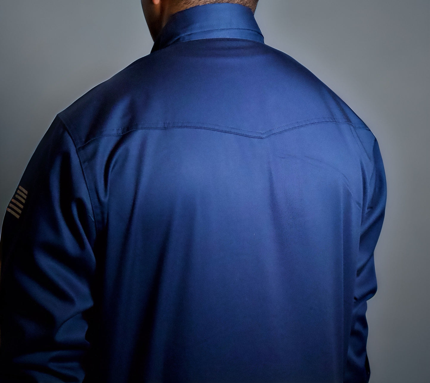 Long-sleeve Western-style shirt with a bold pattern, pearl snaps, and traditional yoke accents on the front and back