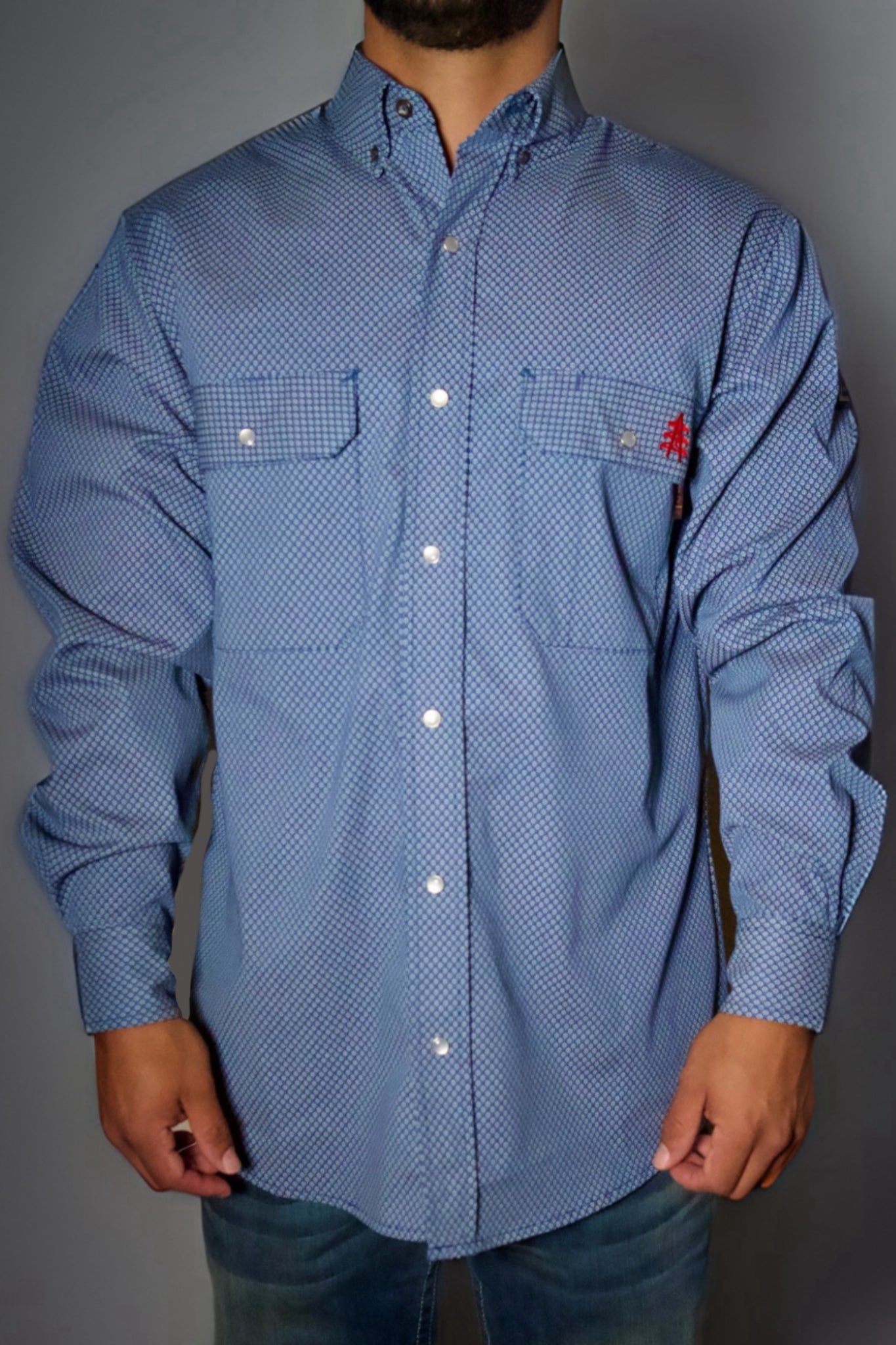 Men’s long-sleeve pearl snap shirt in a classic Western style, featuring front flap pockets, snap-button closures, and a plaid pattern